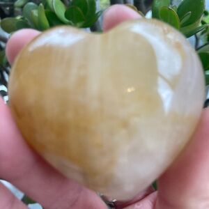 Golden healer polished heart palmstone